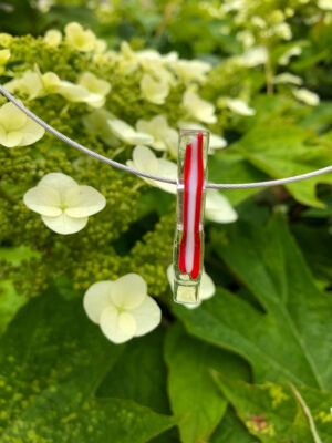 Handgemaakt glasjuweel aan een roestvrij stalen halsring, een ontwerp van Marleen Dotselaere.